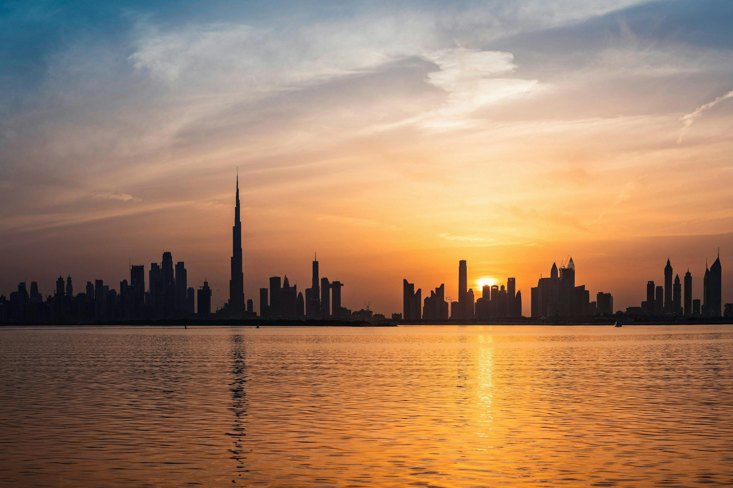 Dubai towers lit up at dusk